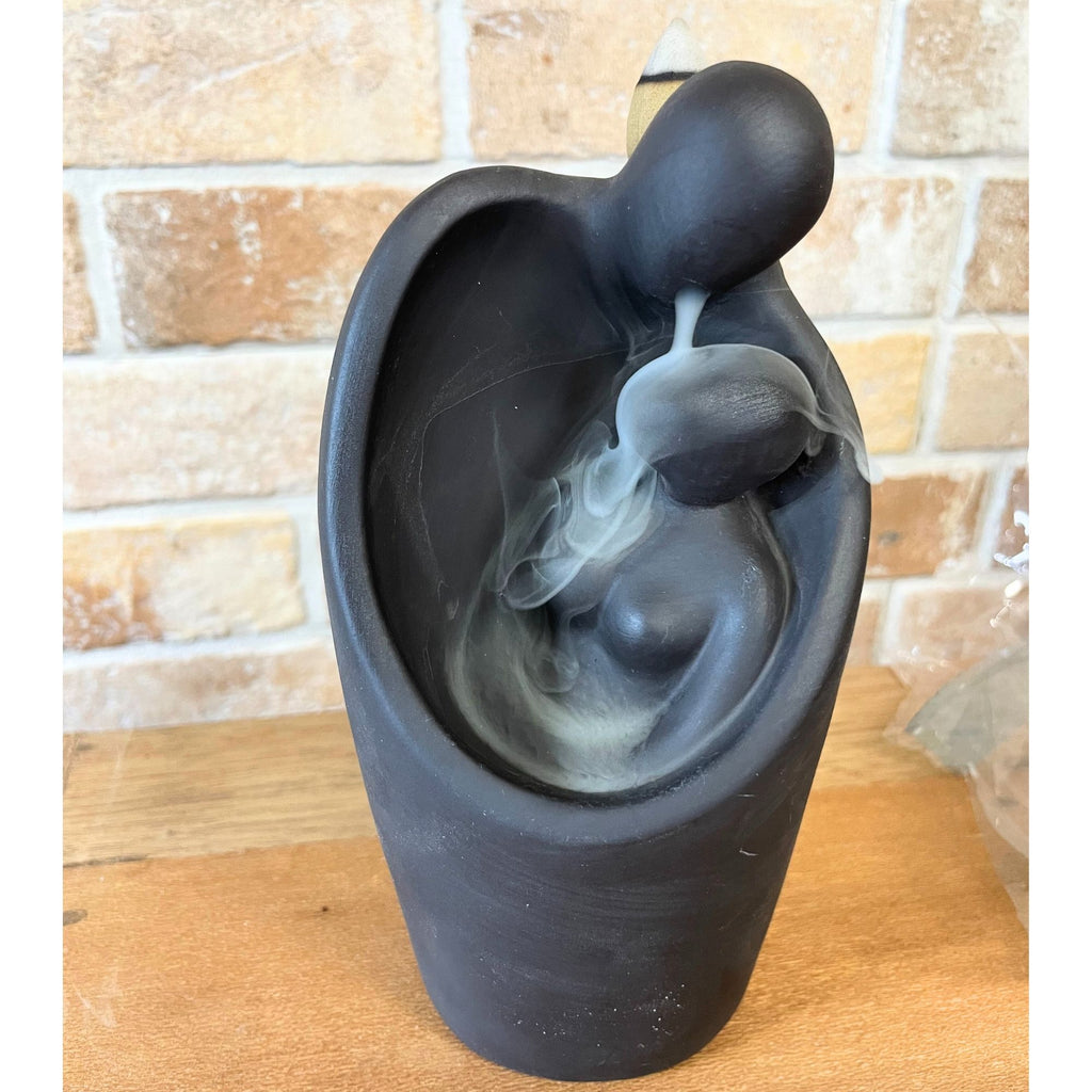 Matte black backflow burner shaped as two figures embracing, on rumpled linen - view 4