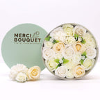 Round box packed with white and ivory soap roses, seen from above on cotton-rag paper - view 3