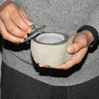 Small grounding pot carved from a single riverstone, with a fitted stone lid, rough outside and smooth within - view 6