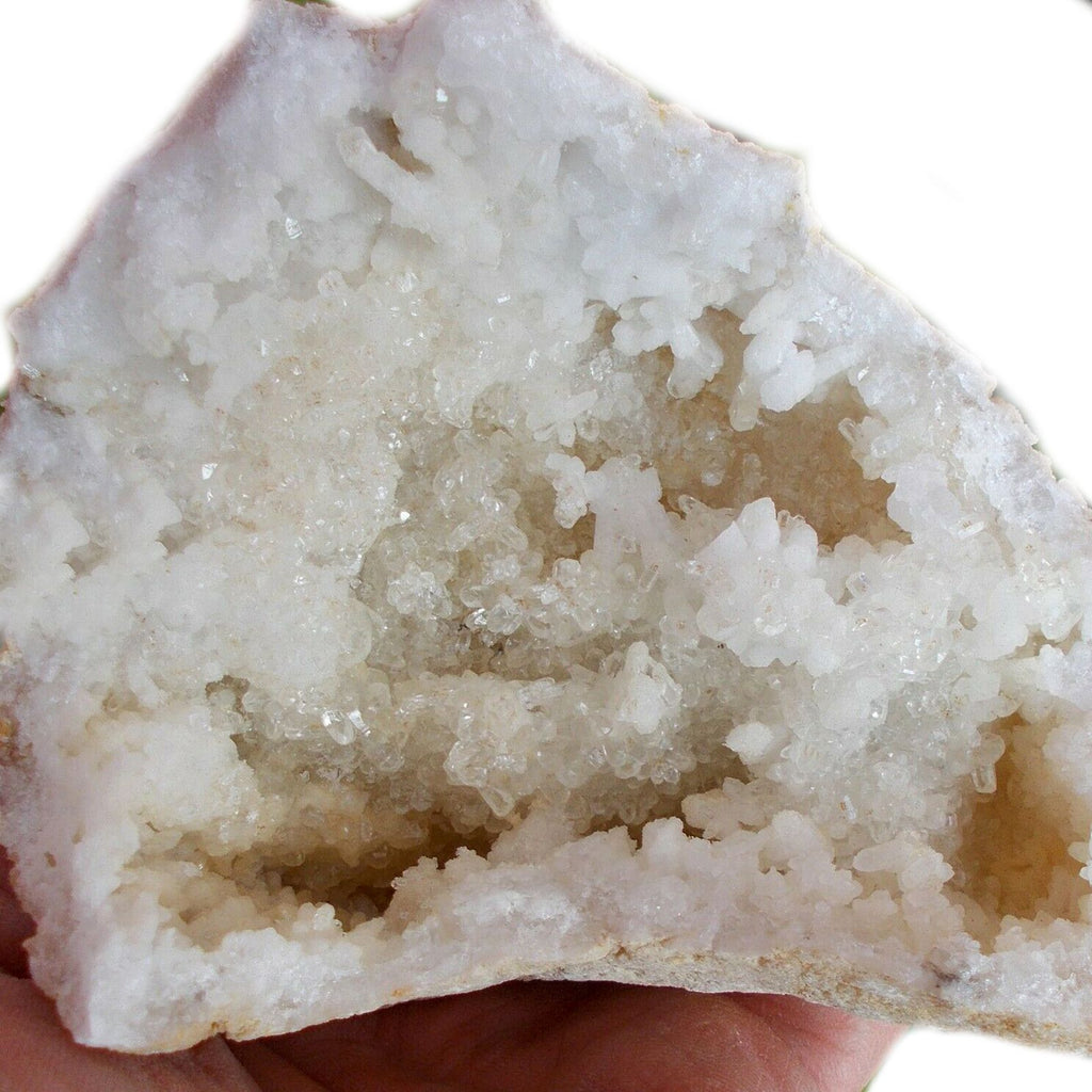 A rough unopened calcite geode resting on cotton-rag paper - view 8