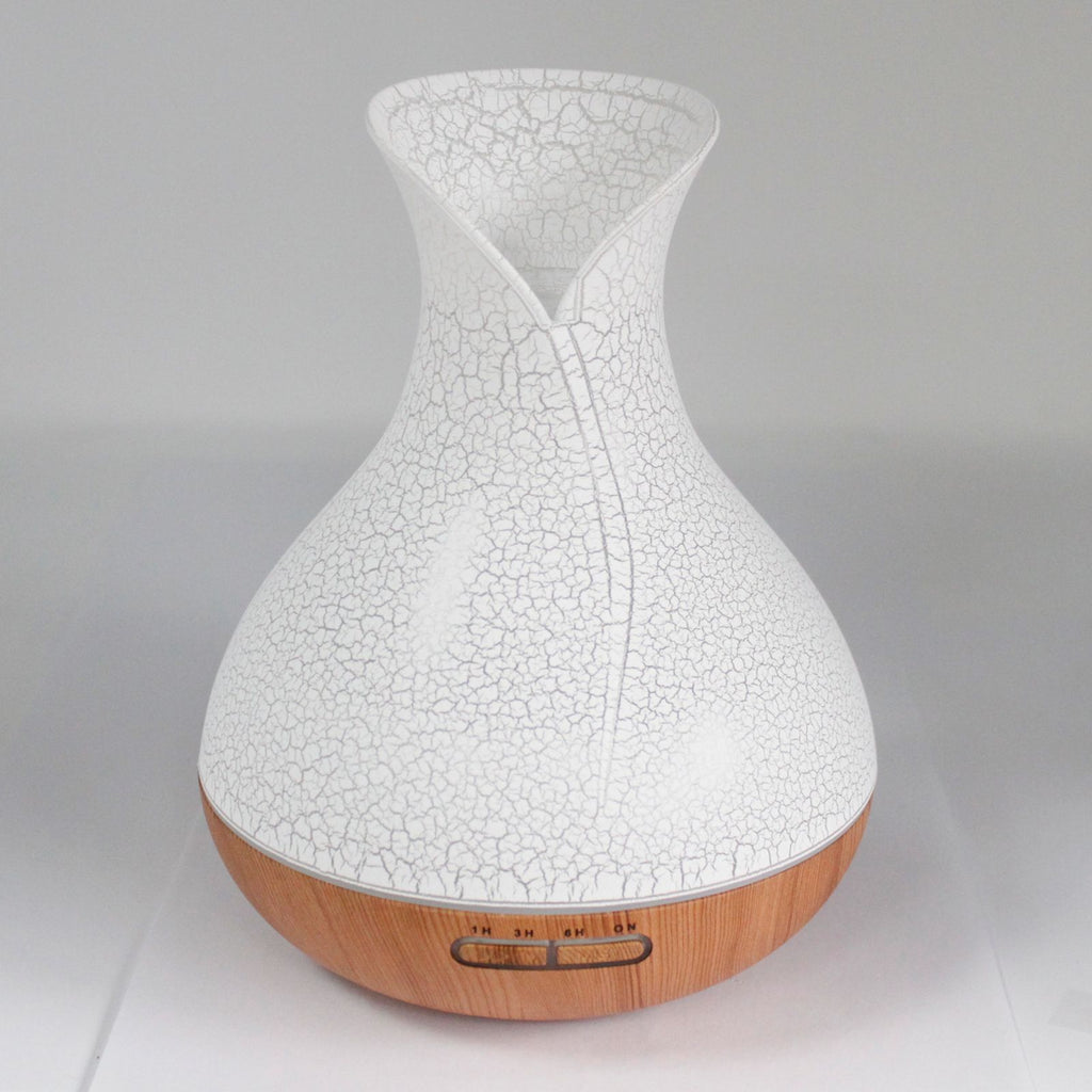 White crackle-glaze vase-shaped aroma diffuser on a wood base