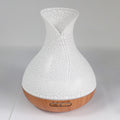 White crackle-glaze vase-shaped aroma diffuser on a wood base