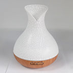 White crackle-glaze vase-shaped aroma diffuser on a wood base