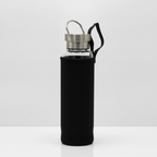 Clear quartz crystal glass water bottle on a clean white surface against a white wall