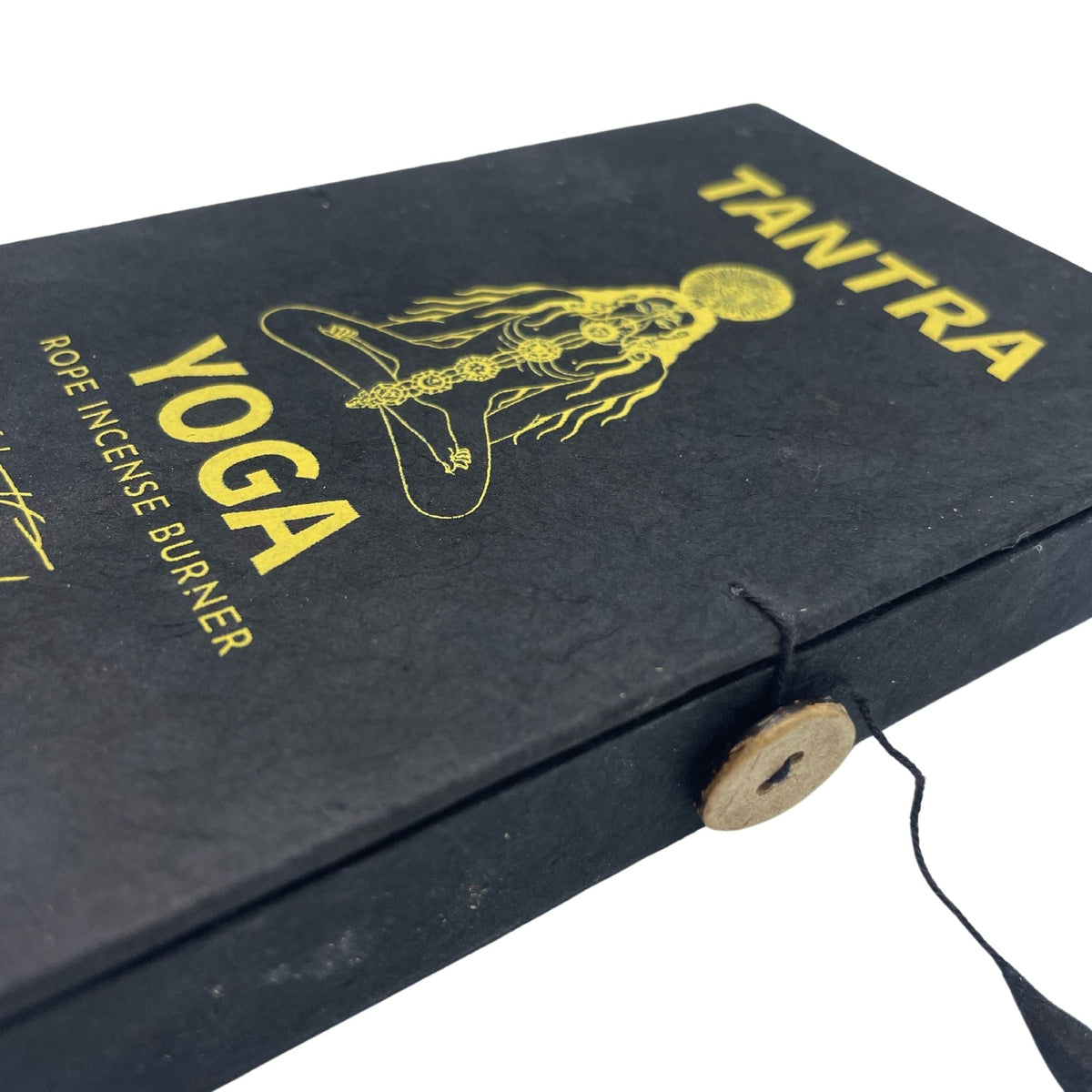 Close-up of the Tantra Yoga box lid with gold lettering and a button and string clasp