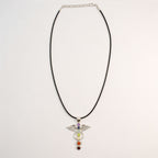 Angel wing pendant with seven chakra stones on a black cord with an adjustable chain