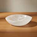 Pointed oval selenite bowl, polished inside with a raw white rim