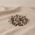 Mixed natural gemstone tumbled chips on natural linen