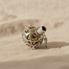 Silver angel bell pendant Night-time with black stone on natural linen