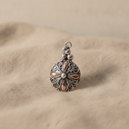 Silver and gold classic round filigree pendant on natural linen