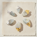 Six assorted Indian sodalite silver plated pendants on cotton rag paper