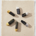 Six assorted Indian black tourmaline silver plated pendants on cotton rag paper