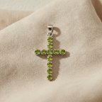 Peridot crucifix pendant on natural linen