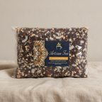 Sealed 1kg bag of Artisan Tea Hidden Islands Blend on natural linen