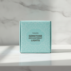 Celestite crystal fairy lights on a marble table with a marble wall behind