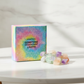 Mixed gemstone crystal fairy lights on a marble table with a marble wall behind