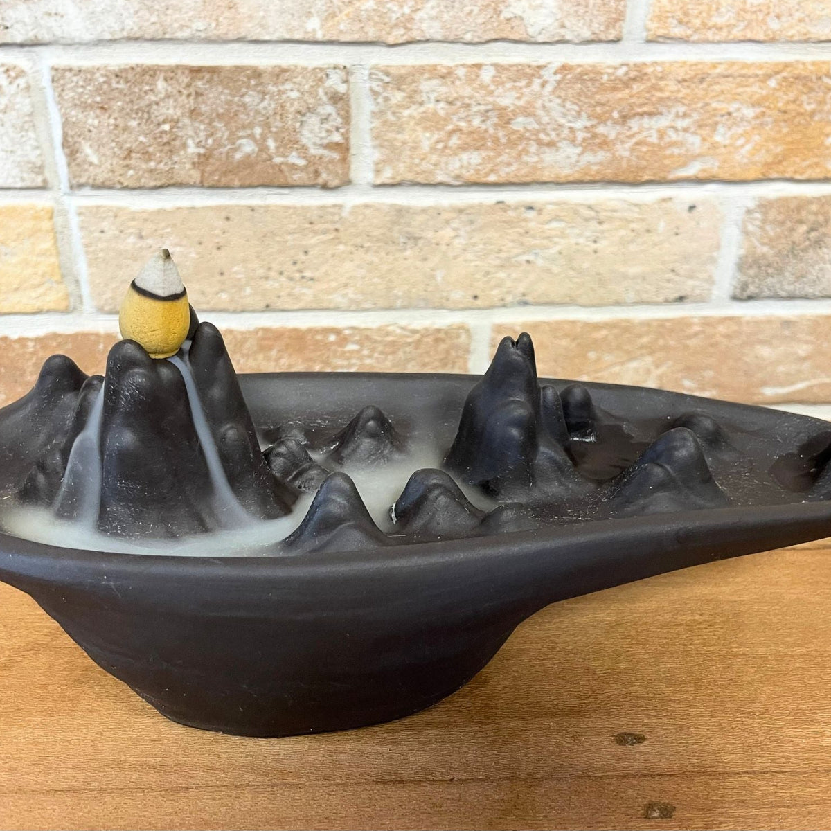 Mountain scape backflow incense burner with smoke running down the slopes - view 2