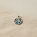 Silver Tree of Life pendant set over blue-green abalone shell