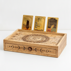 Sun and moon tarot box closed with three tarot cards displayed upright in the slot