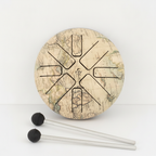 Atlas steel tongue drum from above with a world map finish and two rubber mallets