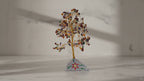 Large multi gemstone crystal tree on a marble table, sunlight moving across the wall
