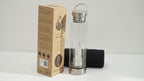 Video of the clear quartz crystal glass water bottle with its box and padded sleeve, with the camera slowly moving in