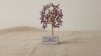 Small amethyst chipstone tree on a hand-painted stone base, on rumpled linen video
