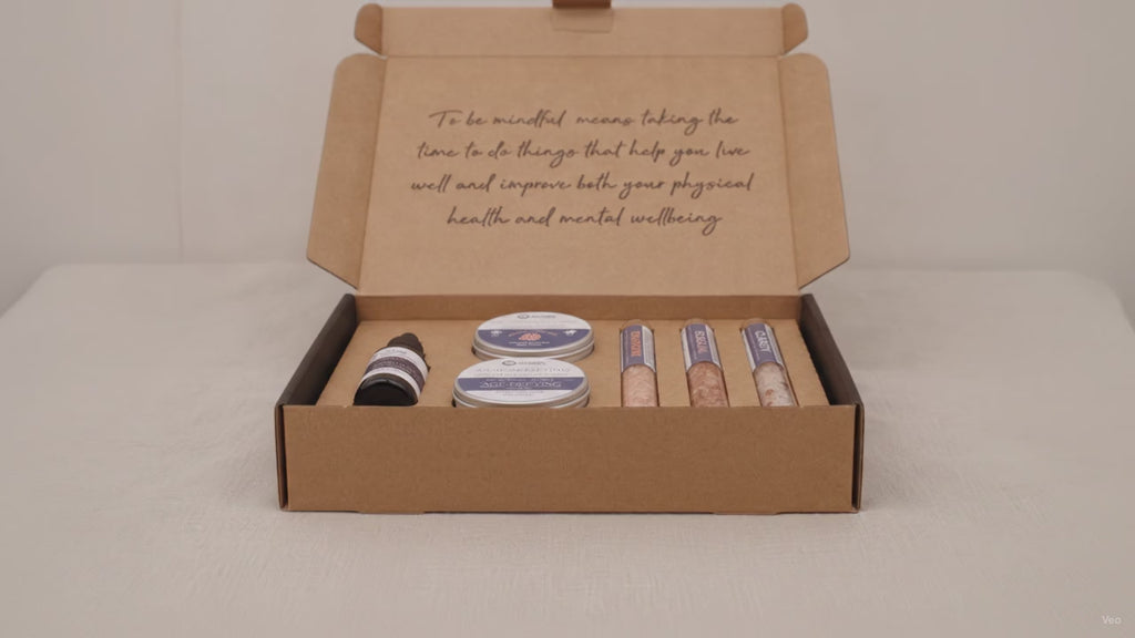 Dark self-care kit box lying flat and closed on rumpled linen video