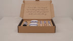 Dark self-care kit box lying flat and closed on rumpled linen video