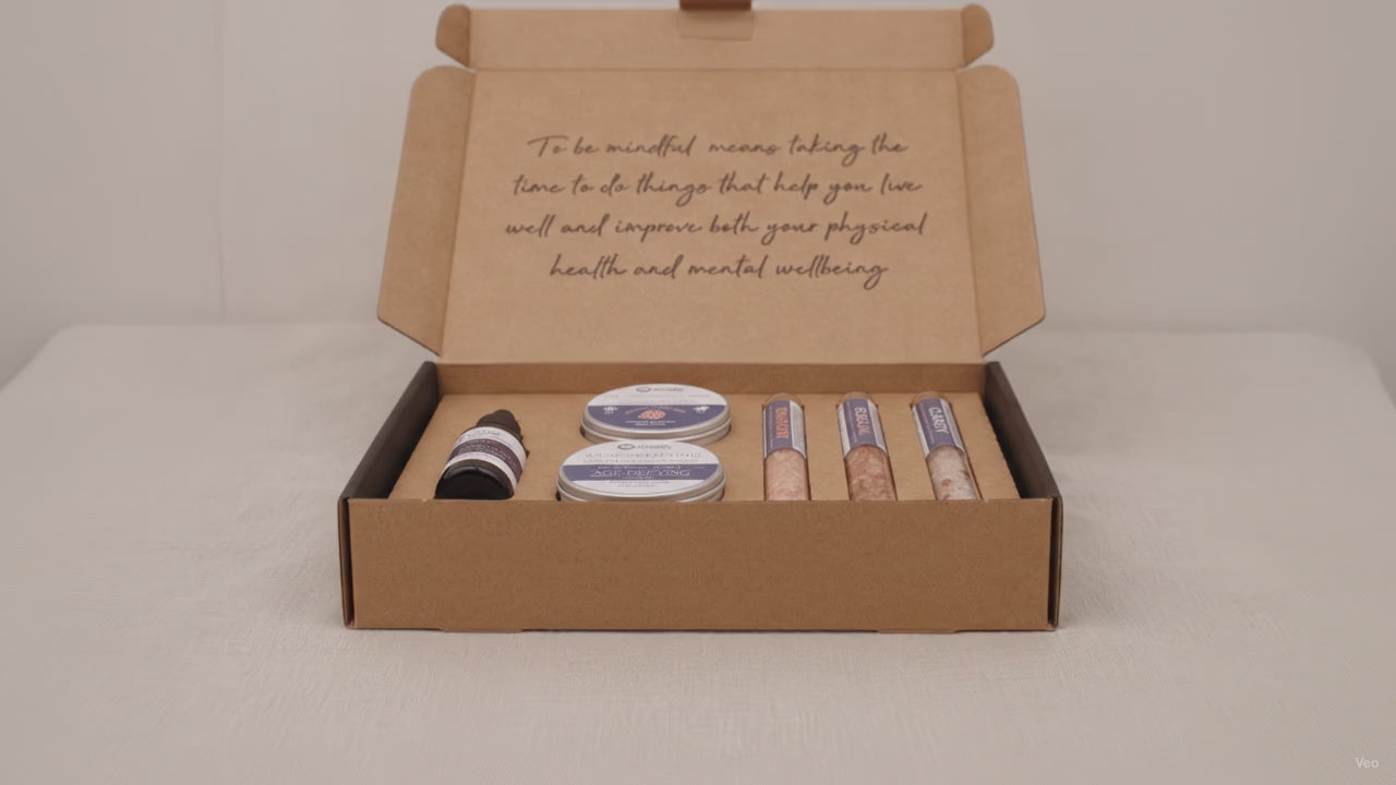 Dark self-care kit box lying flat and closed on rumpled linen video