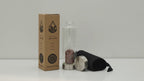 Red jasper chips crystal water bottle with its box, lid and padded sleeve, soft light moving across the wall
