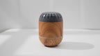 Video of the Copenhagen wood-effect aroma diffuser with a soft wisp of cool mist, the camera slowly moving in