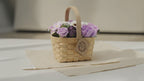 Lilac and purple soap roses in a woven wicker basket with a tag, on cotton-rag paper video