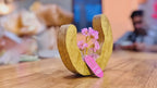 Rose quartz gemstone tree in a mango wood open ring, slow product video