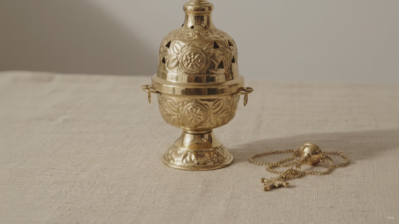 Ornate brass hanging incense burner standing on its footed base, chains beside it video
