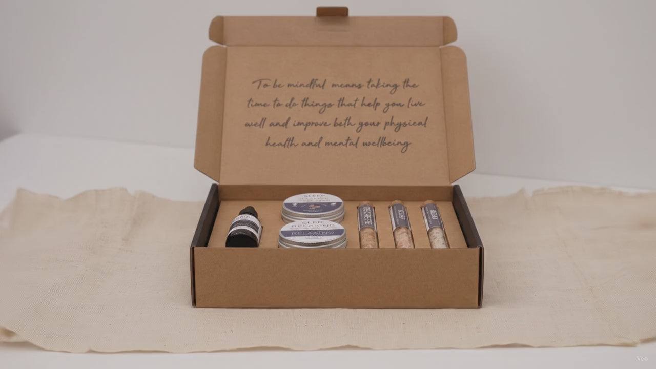 Kraft self-care kit box open flat, showing scrub tins, serum bottle and bath salt tubes video