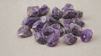A spread of rough amethyst chunks in deep purple on cotton canvas video