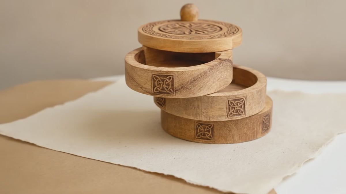 Carved wooden Celtic box with its three tiers fanned open, on cotton-rag paper video