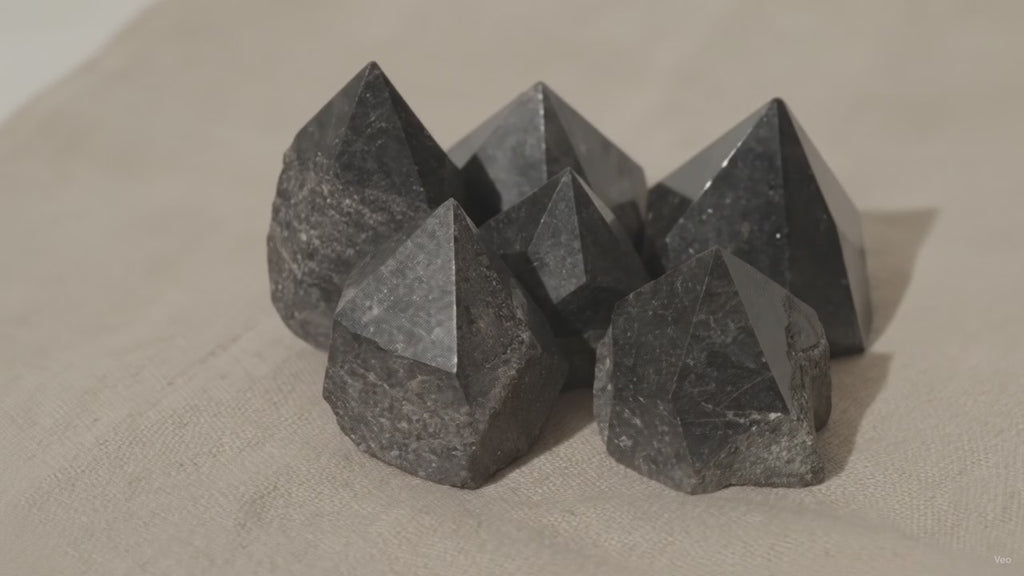 Polished black tourmaline crystal points grouped together on natural linen video
