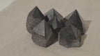 Polished black tourmaline crystal points grouped together on natural linen video