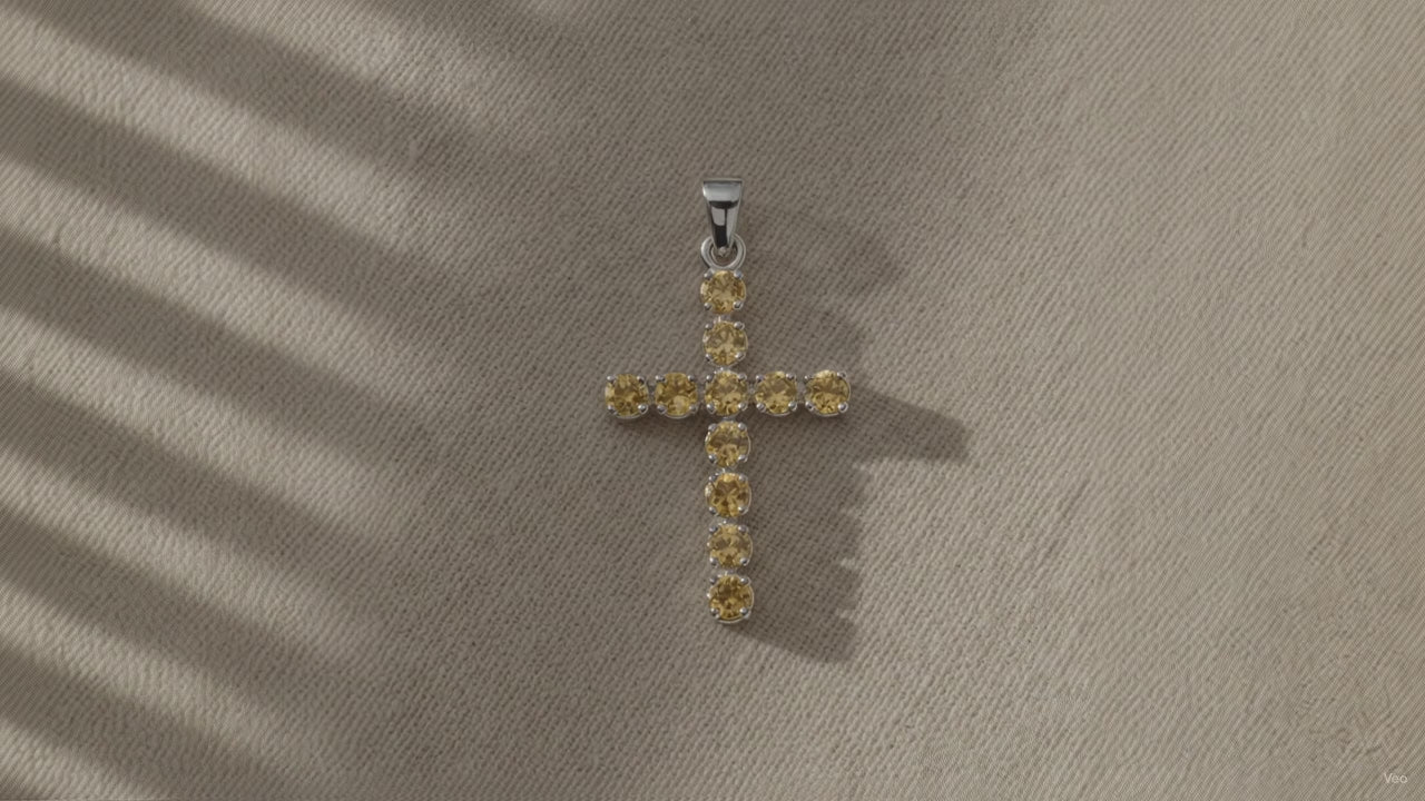 Silver-plated crucifix pendant set with golden citrine-coloured stones, on linen video