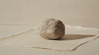 A rough unopened calcite geode resting on cotton-rag paper video