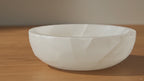 Round selenite bowl, polished inside with a raw white outer wall - video