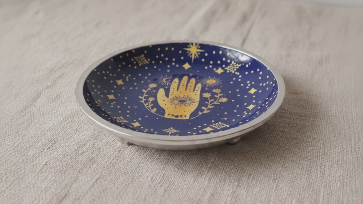 Midnight blue enamelled dish with a golden hamsa hand, standing on three legs video