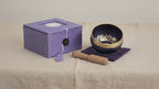 Brass and black singing bowl with striker, purple cushion and lilac box video
