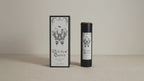 Black Witches' Queen candle tube beside its illustrated box, on cotton canvas video