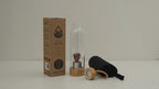 Red jasper angel crystal water bottle with bamboo lid, box and padded sleeve, soft light moving across the wall
