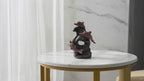 Dolphin wave backflow incense burner on a marble table, slow product video