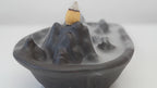 Mountain scape backflow incense burner with smoke running down the slopes video