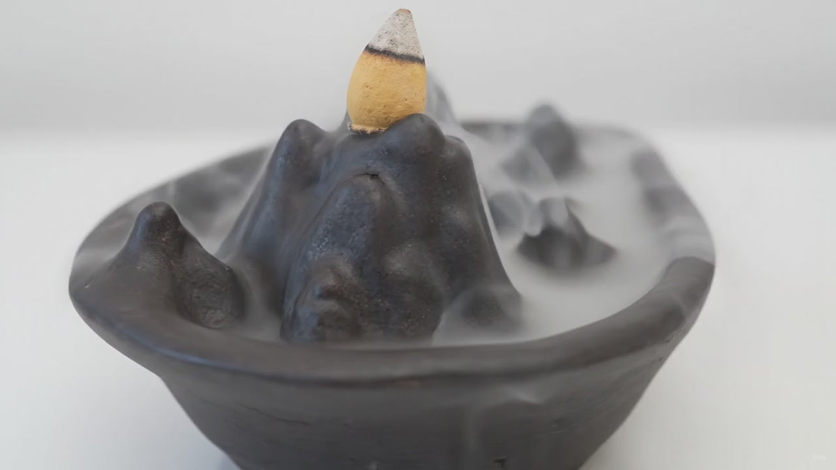 Mountain scape backflow incense burner with smoke running down the slopes video